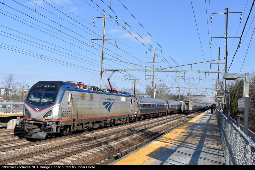 Amtrak Train # 195 being pulled by Sprinter # 656 passing a stopped Amtrak Train # 164